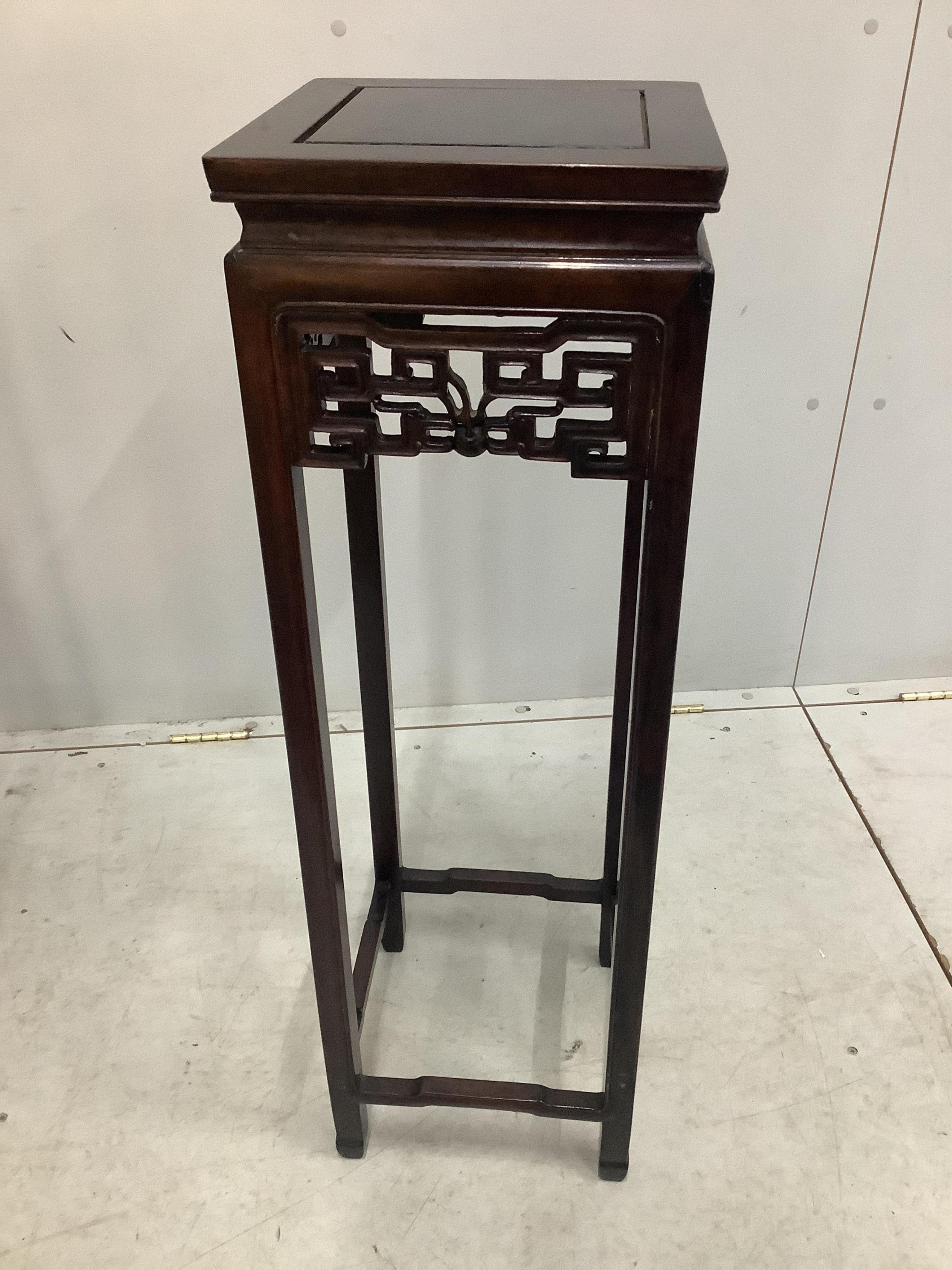 A pair of Chinese square hardwood vase stands, width 28cm, height 92cm. Condition - fair